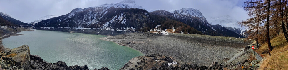 A large reservoir lake - Lai da Marmorera in the European Alps. Switzerland, Springtime.