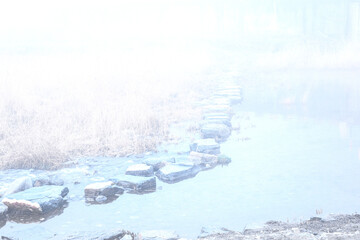 Spring morning bridge landscape. Fogy and misty rises from the river.