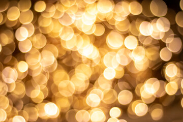 The background is made of golden bokeh. Abstract blurred background