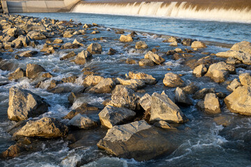 A rocky shoreline with a river flowing through it