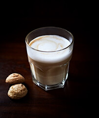 Coffee with milk on rustic wooden background. Soft focus. Close up. Copy space.	
