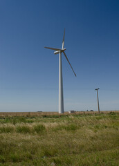 windmills with wind energy turbines in the countryside to generate clean energy