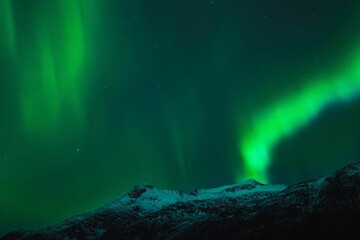 Stunning winter landscape with an Aurora Borealis (Northern Lights) display in the night sky