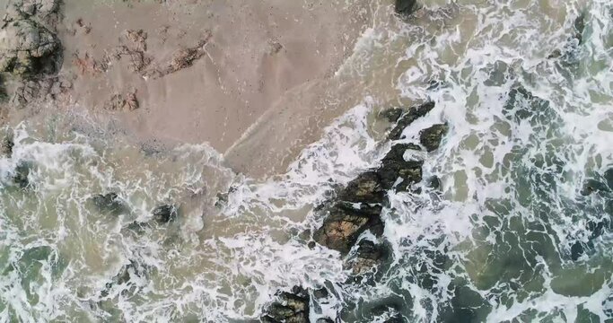 aerial image of the coast with waves and rocks