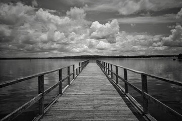 Grayscale shot of a pier at a Mississippi reservoir