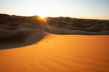 a desert view with the sun shining behind it at sunset
