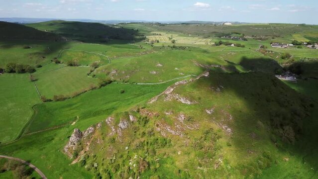 Drone shot over Parkhouse Hill with green fields and meadow