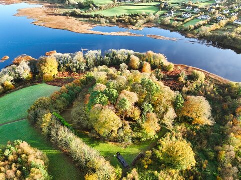 Aerial shot of the Killaloe coastal town surrounded by colorful autumn trees