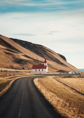 Reynisfjara Lutheran church with the road on the way to Reynisfjara beach in autumn at Vik, Iceland