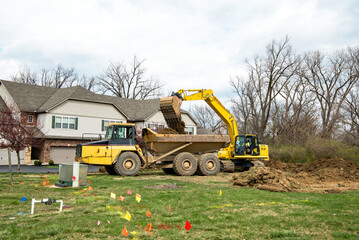 Backhoe Loading Excavated Soil into Truck