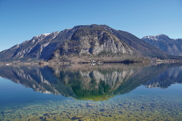 Fototapeta na wymiar Picturesque view of the lake with the reflection of the rocky mountain, Hallstatt, Austria.