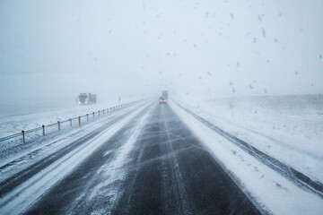 Car driving on snow covered highway road and blizzard with windy in countryside at Iceland - 773155195
