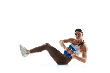 Young woman doing seated dumbbells, weights russian twist in motion against white studio background. Concept of sport and recreation, movement, self care, action, energy. Ad