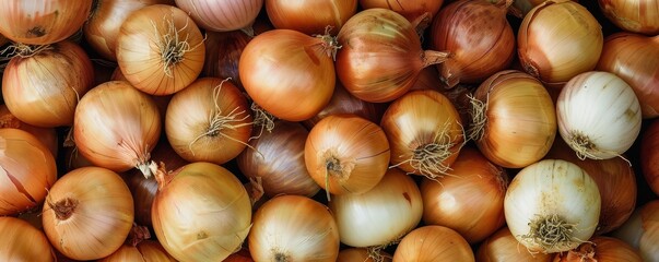   A pile of onions stacked upon one another, atop another stack