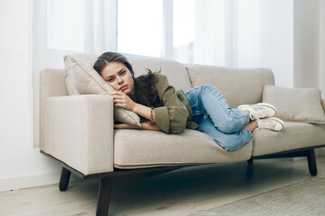 Obraz premium Lonely Woman on Couch, Stressed and Depressed, Feeling Sad and Worried, in Pain, at Home: Depressed Mood on Sofa