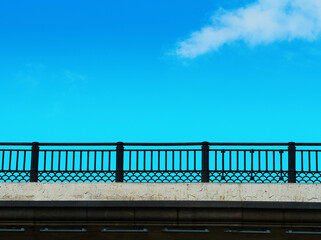 Horizontal bridge fencing under the daylight sky backdrop