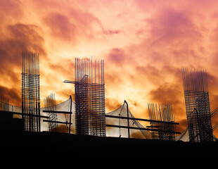 Building reinforcement illuminated by dramatic sunset backdrop