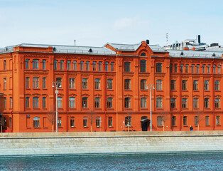 Red brick building on river embankment