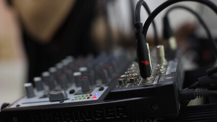 Close up of professional audio mixer in recording studio, shallow depth of field