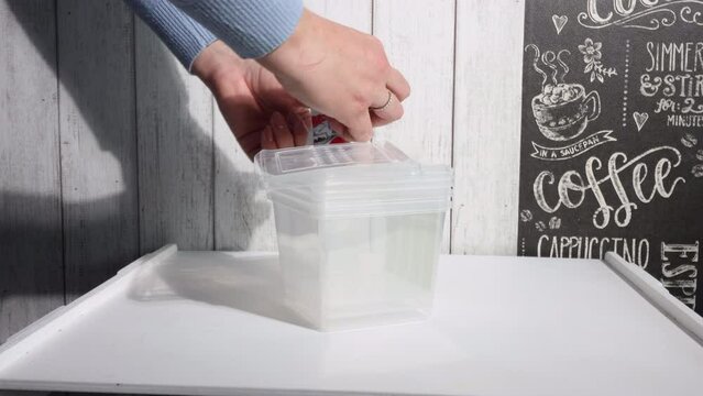 Plastic containers for freezing and storing food. A woman reviews a purchase.