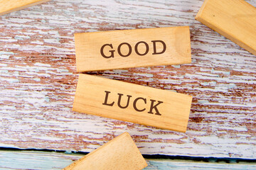 GOOD LUCK symbol on wooden blocks on old boards. Business concept