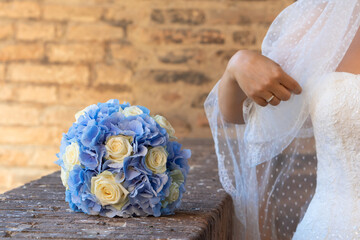 bride's bouquet of blue and white flowers on wedding day