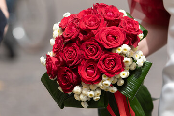 vibrant red rose bouquet with white accents for a wedding