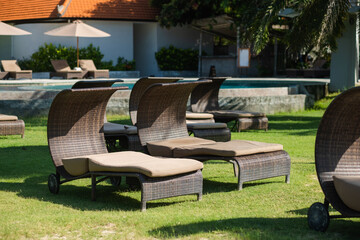Beach beds with umbrellas, on the ocean coastline, on the hotel grounds among greenery.