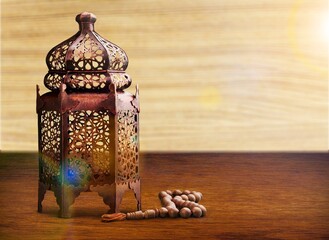 Golden metal arabic lantern on the desk