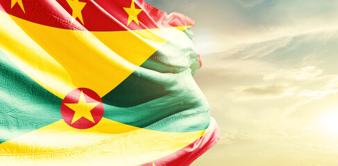 Grenada national flag waving in the sky.