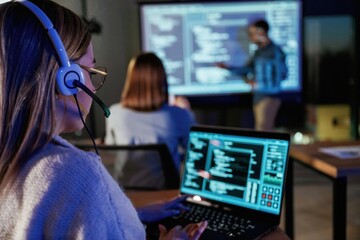 Audience is with laptops. Male business trainer is against projector with data, teaching people