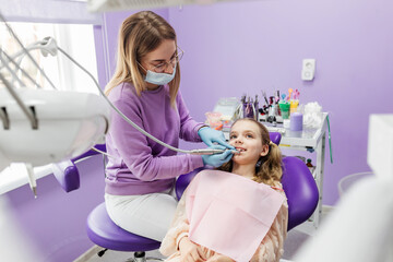 The process of using a dental brush during the stages of a professional teeth cleaning procedure in...