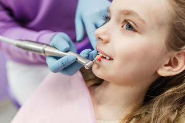 The process of using a dental brush during the stages of a professional teeth cleaning procedure in a clinic