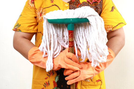 Closeup photo of asian woman housekeeper standing while holding mop