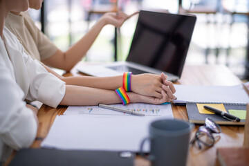 Expression of freedom and love concept. Show off symbolism by wearing a rainbow-colored wrichband. Pride month concept.