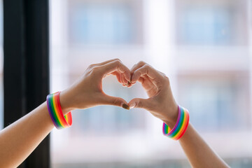 Expression of freedom and love concept. Show off symbolism by wearing a rainbow-colored wrichband....