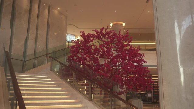Interior design of building features staircase with tree backdrop