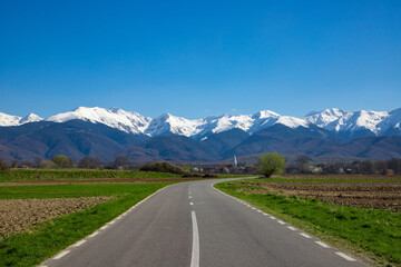 Landscape with Fagaras mountains in the distance, covered with snow