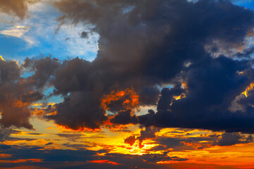 Colorful dramatic sky with cloud at sunset. Fantastic heaven with awesome dark clouds 