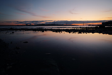 Sunset on Tagus river in Lisbon. View on Bridge