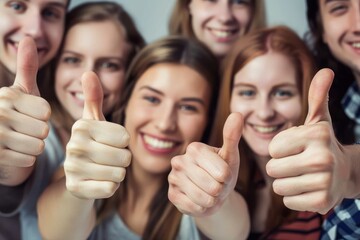 A close-up image featuring a group of young adults smiling and giving a thumbs up, expressing positivity and approval - obrazy, fototapety, plakaty