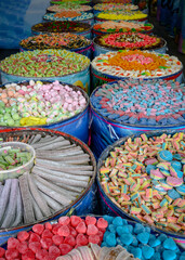 Barrels with colorful candies and marmalade