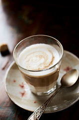 Coffee with milk on rustic wooden background. Soft focus. Close up. Copy space.