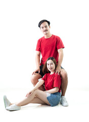 Fototapeta na wymiar Young Asian couple isolated on white background,Young attractive Asian couple wearing red t shirt and white shorts standing together, woman holding bouquet of flower against white background. Concept 
