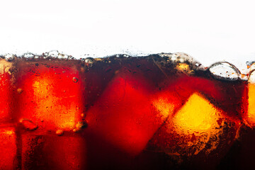 Cola drink and ice cubes close-up,Ice cubes in cola beverage, close up