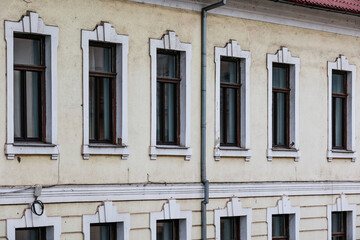 Fototapeta na wymiar Urban building facade. Windows, brick wall. Detail.