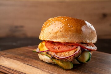 Burger on a wooden board with drink