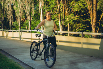 middle-aged latin woman walking safely along a paved walkway in a park