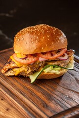 Burger on a wooden board with drink