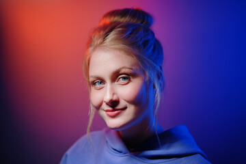 Colorful close-up studio portrait of a young woman